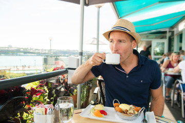 Young man sitting tourist sit for the breakfest with coffee