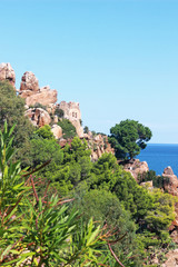 rocks and ruins near the mediterranean sea, green trees and bushes