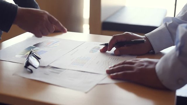 Businessmen are working together. Analysis of financial data in the document. Presented at the meeting.