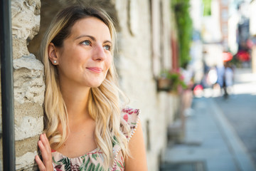 Fashion woman portrait of young pretty trendy girl posing on the quebec city street