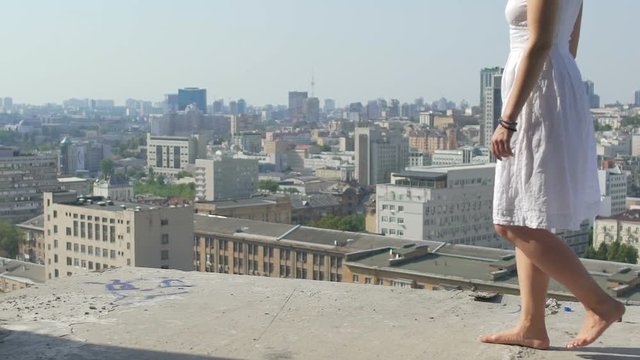 Reckless woman walks on edge of construction site no fear of height suicide fall