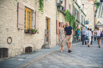 Outdoor lifestyle portrait of young couple in love in old town