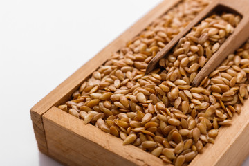 Seeds of golden flax on a white background