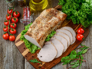 Delicious spicy meat. Spicy meat baked with chili pepper. Piece of baked meat with spices and vegetables on the table.