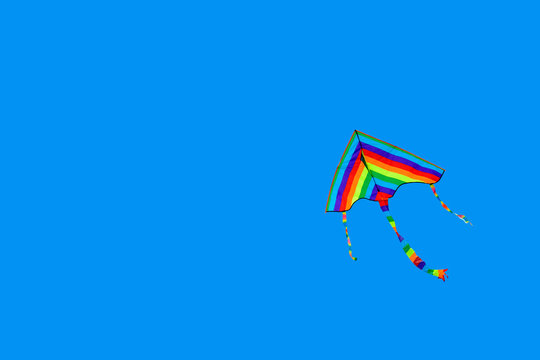 Rainbow kite on a colored background