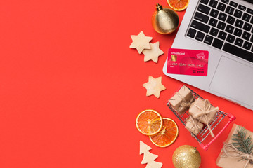Christmas online shopping background. Laptop, credit card and decorations
