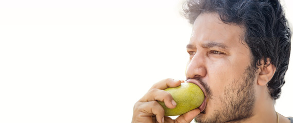 Indian man eating mango on white background