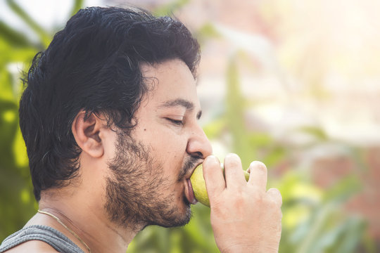 Indian Man Eating Mango.