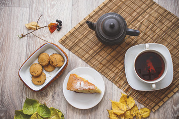 Old black teapot on the straw bedding.