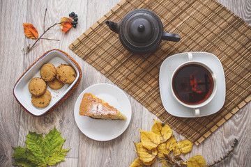Old black teapot on the straw bedding.