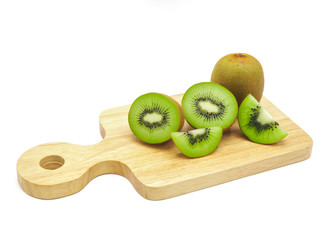Slice of fresh juicy delicious and healthy kiwi fruit on wooden chopping board, isolated on white...