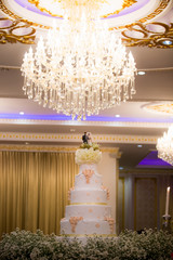 Figurines of the bride and groom on a wedding cake Corny wedding cake that symbolizes the commitment to love one another