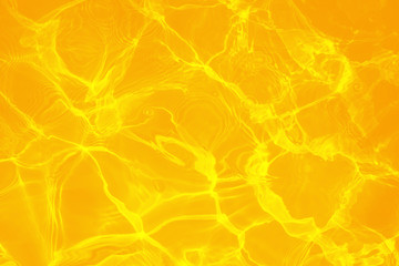 Rippled pattern of clean water in a orange swimming pool for background