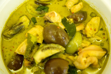 Thai chicken green curry with old wooden background.closeup green curry with chicken (Kang Keaw Wan Gai) isolated on white background, Thai local food.