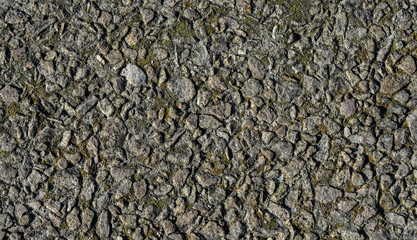 Grey stone wall background with green and yellow moss. Old stone wall texture for banners, flyers and design.