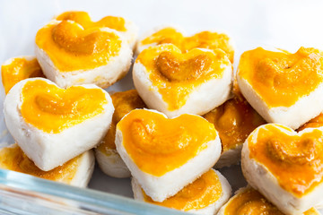Heart shape cookies with cashew nut or Singapore Cookie in glass bowl on white table background for valentines day element concept design.