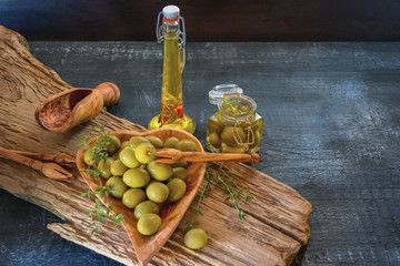 green olives are on the table in a bowl of olive tree. The concept of healthy eating