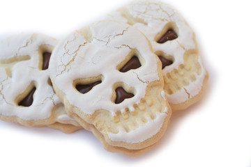 Halloween cookies filled with chocolate cream in shape of a skull isolated on white background

