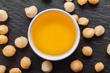 delicious macadamia nuts on a dark stone background