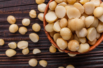 delicious macadamia nuts on a wooden rustic background