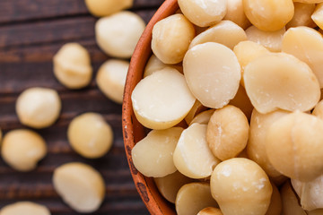 delicious macadamia nuts on a wooden rustic background