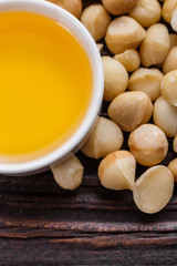 delicious macadamia nuts on a wooden rustic background