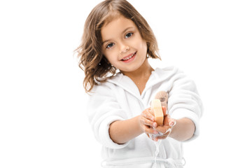portrait of smiling kid in bathrobe washing hands with soap isolated on white