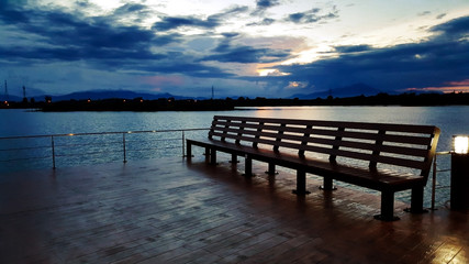 outdoor wood bench with view of river in park