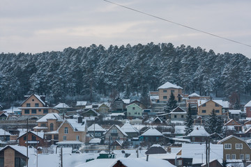 winter village in the mountains. snow-covered houses on a frosty winter day
