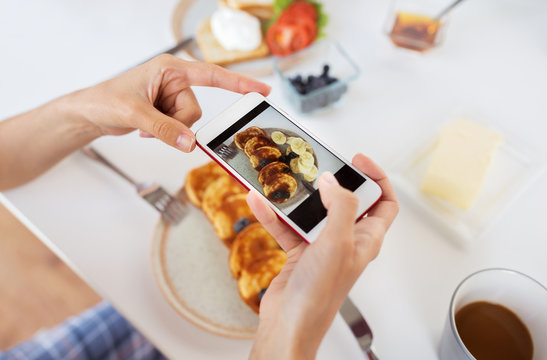 food , eating and technology concept - hands with smartphones photographing breakfast on plate