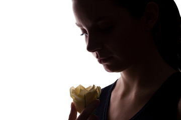 Young woman look on flower - horizontal silhouette of a side view