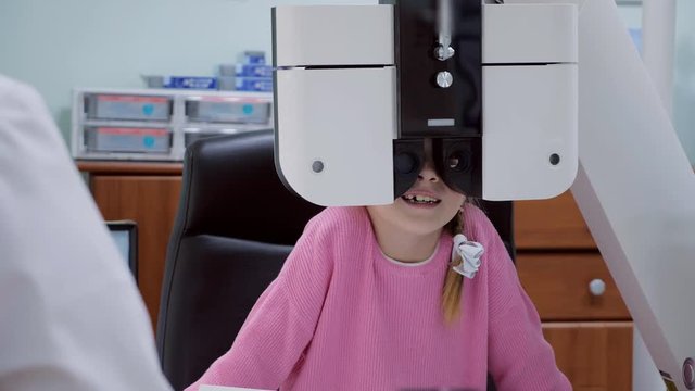 Close up of a little girl an eyes test in the clinic.