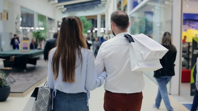 Couple walking through the mall. shopping theme