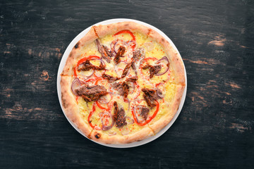 Pizza with Veal and Mozzarella. Beef, tomatoes, pasta pomidorro. Italian traditional dish. On the old background. Top view. Free space for your text.