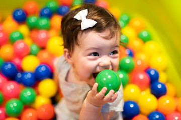 Fototapeta na wymiar Portrait of a adorable infant on colorful balls