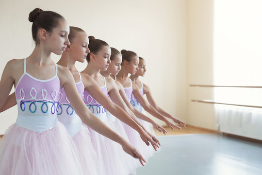 Group of young girls dancing ballet in studio