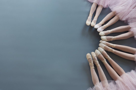 Little Ballerinas Legs In Pointe Shoes On Floor