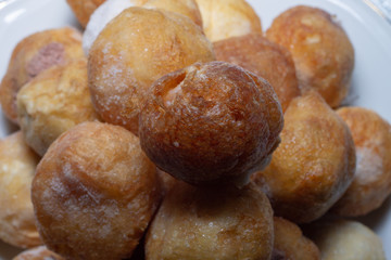 dish of mixed buñuelos of wind for the time of all the saints typical in Spain