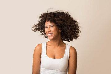 African-american woman fooling with her curly hair
