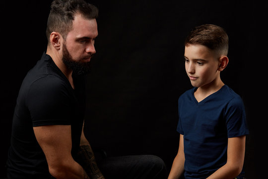 Father And Son, Serious Talk On Black Background