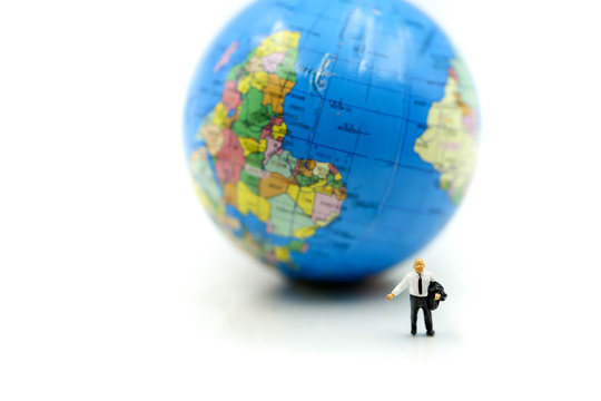 Miniature people : Businessman standing with Global World map balloon,Success Business Due around the world and Strategy Planning concepts.