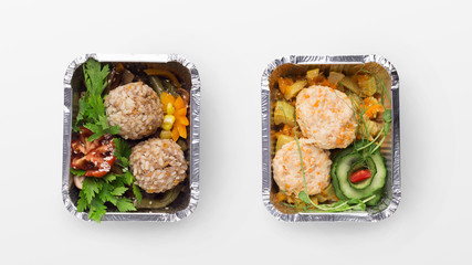 Set of take away difhes in black containers