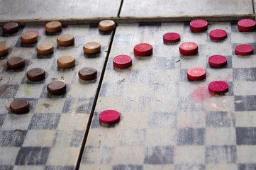 Vintage wooden red and brown checkers on old board game