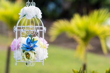 Wedding decoration.Romantic valentine decorate with flowers and a white engraved cage 