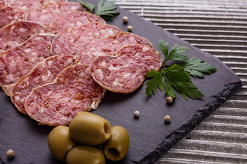 Saucisson sec delicious french salami on a wooden background