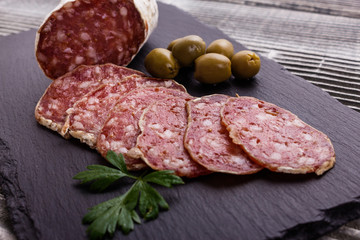 Saucisson sec delicious french salami on a wooden background