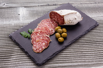 Saucisson sec delicious french salami on a wooden background