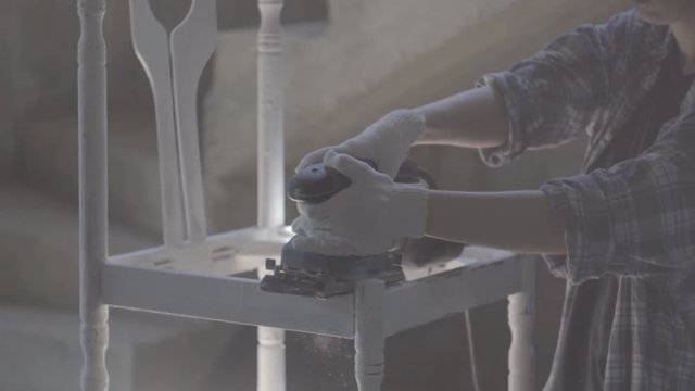 Girl carpenter, designer, works with electric tool