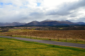 Scottish Highlands overlooking the countryside with green and white hills 