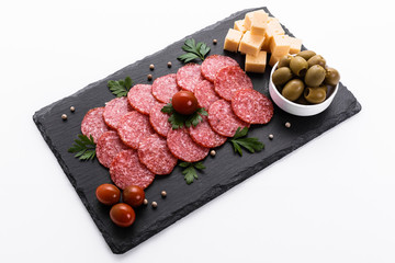 delicious sliced salami on a stone plate white background